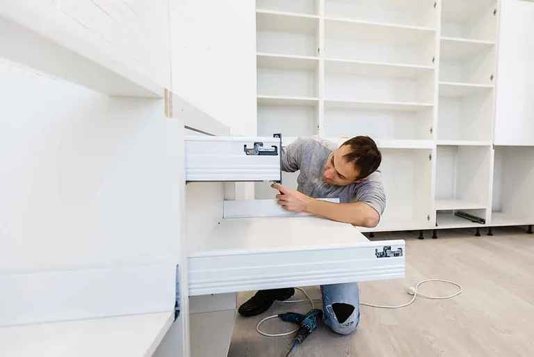 Trades man installing a kitchen